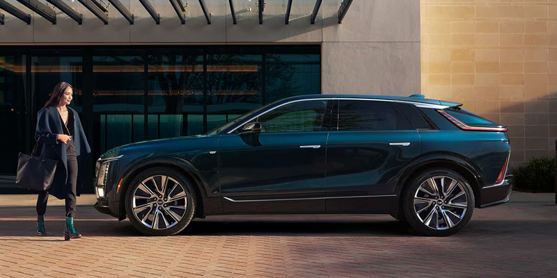 Woman walking past a Cadillac Lyriq EV